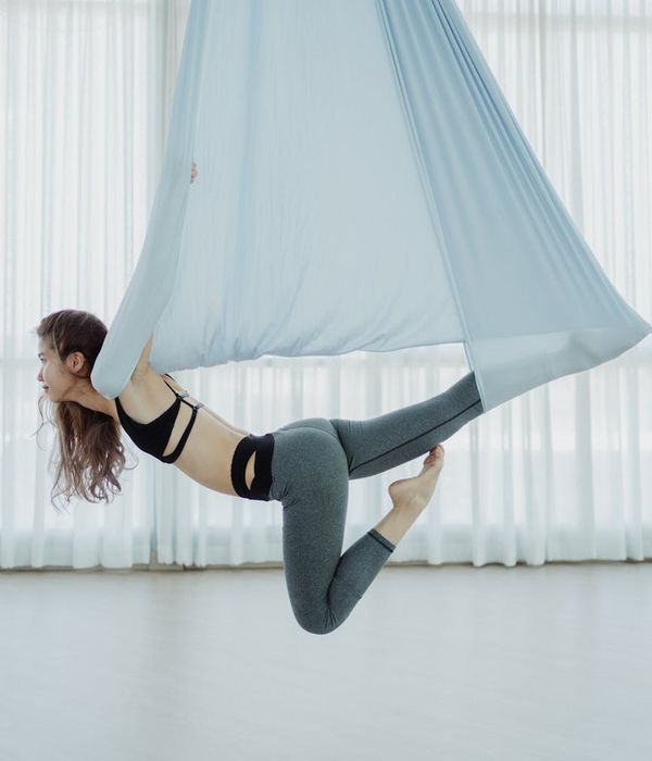 Athletic man in a focused yoga pose in a modern studio.